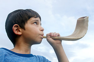 A child blowing a shofar: 9607433